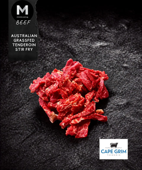 A pile of sliced raw beef stir fry pieces on a dark textured background, with a black label reading 'BEEF AUSTRALIAN GRASSFED TENDEROIN STIR FRY' and a Cape Grim Beef logo in the bottom right corner.