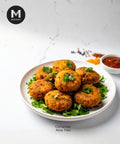 Platter of Coriander Aloo Tikki with a side of chutney on a white background