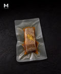 Greenland Halibut fillet marinated in Umami Dashi, skin side with bonito flakes and fresh ginger garnish