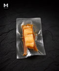 Vacuum-packed Greenland Halibut fillet marinated in Umami Dashi, flesh side up on black background