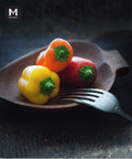 Baby Capsicum on a wood platter