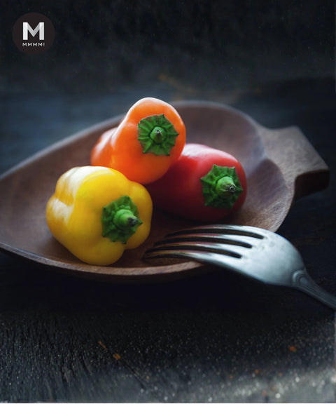 Baby Capsicum on a wood platter