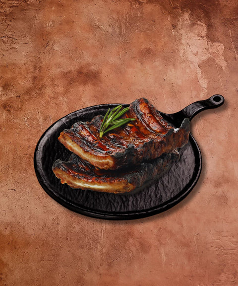 Grilled steak on a black cast iron skillet with a brown background