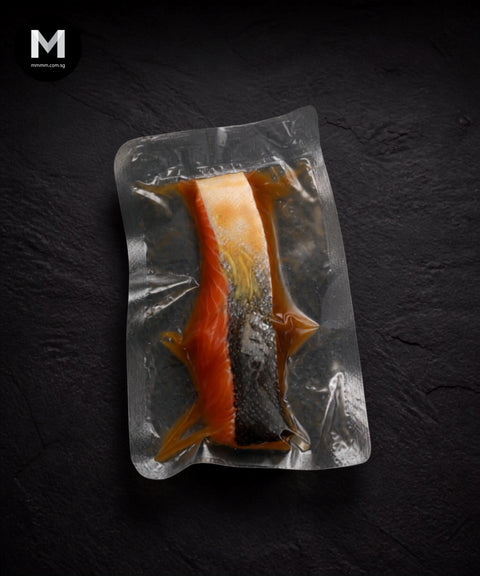 NZ King Salmon fillet marinated in Umami Dashi, skin side showing dark marinade coating in vacuum pack