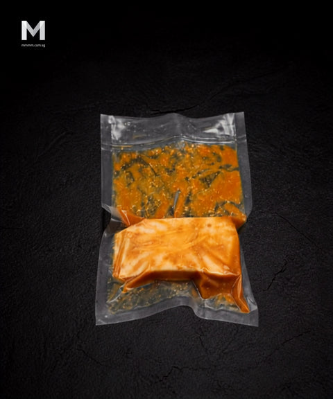 Vacuum-packed Spanish Swordfish fillet marinated in savoury miso blend, on black background