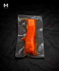 Vacuum-packed Australian Trout fillet marinated in Umami Dashi, flesh side up on black background
