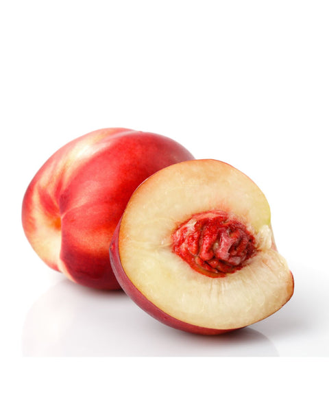 Whole and halved white nectarine on a white background