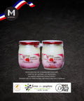 Two jars of  raspberry yogurt with a dark background and branding elements.