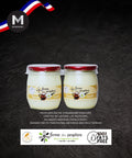 Two jars of vanilla yogurt with a dark background and branding elements.