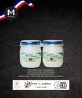 Two jars of plain yogurt with 0% fats and sugar a brand logo on a dark background