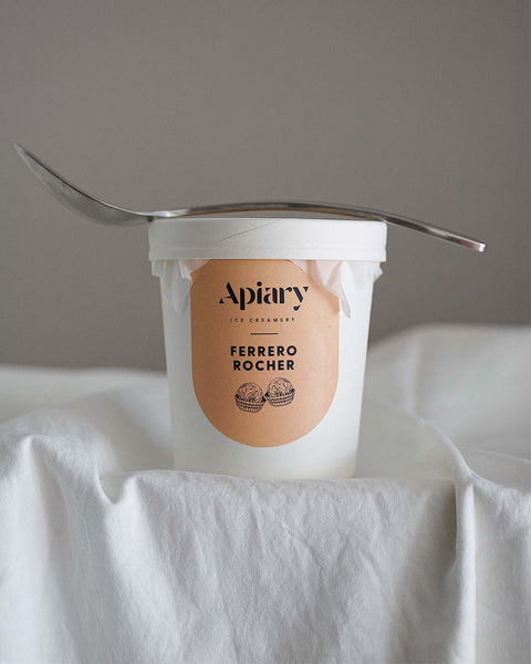 Ice cream container with 'Apiary' and 'Ferrero Rocher' branding on a white surface.
