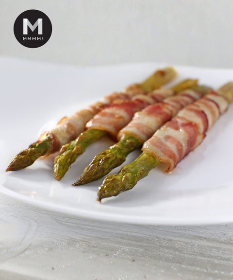 Bacon-wrapped green asparagus spears on a plate