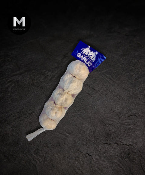 China garlic bulbs packed in a bag on a black background