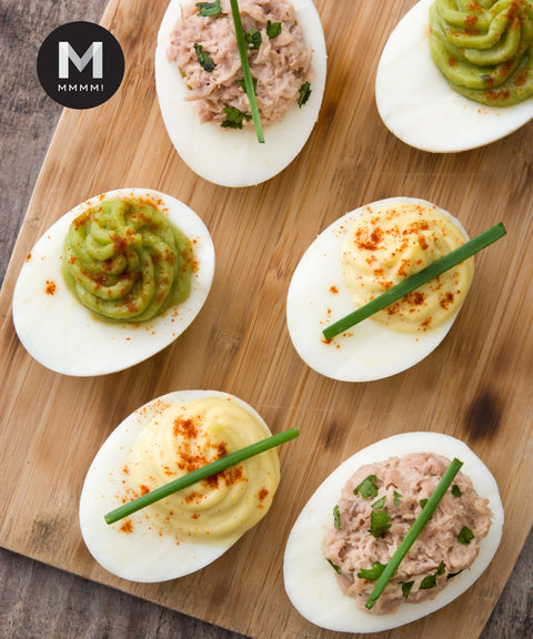 Deviled eggs garnished with chives and chopped Italian flat parsley