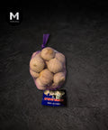 Fragrant garlic bulbs packed in a bag on a black background
