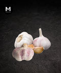Whole French rose garlic bulbs on a black background