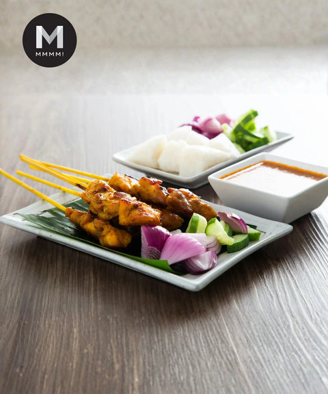 Spanish Red Onion used as garnish in a chicken satay dish with cucumber, ketupat, and peanut sauce