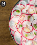 Sliced European Red Baby Radish and onion salad, garnished with spring onion