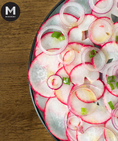 Sliced European Red Baby Radish and onion salad, garnished with spring onion
