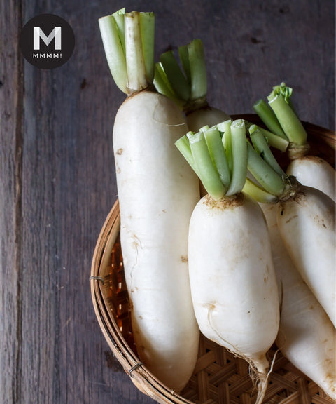White Radish (Daikon) bundle with green stems in a bamboo basket