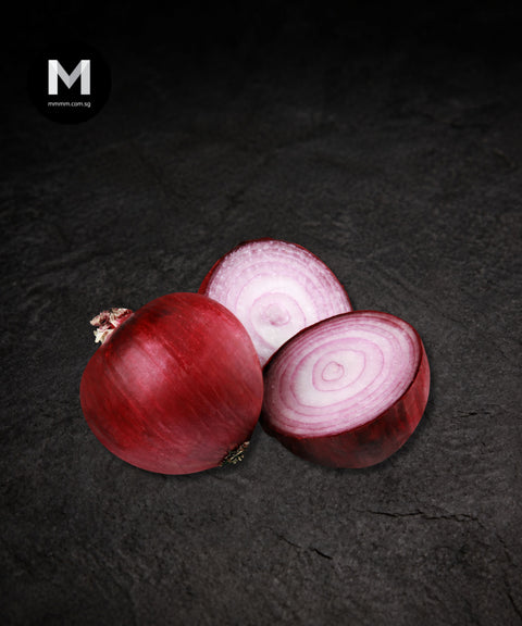 Single Spanish red onion on a black background