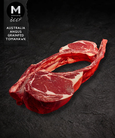 Whole Australian Angus grainfed Tomahawk steak, bone-in, on a black background